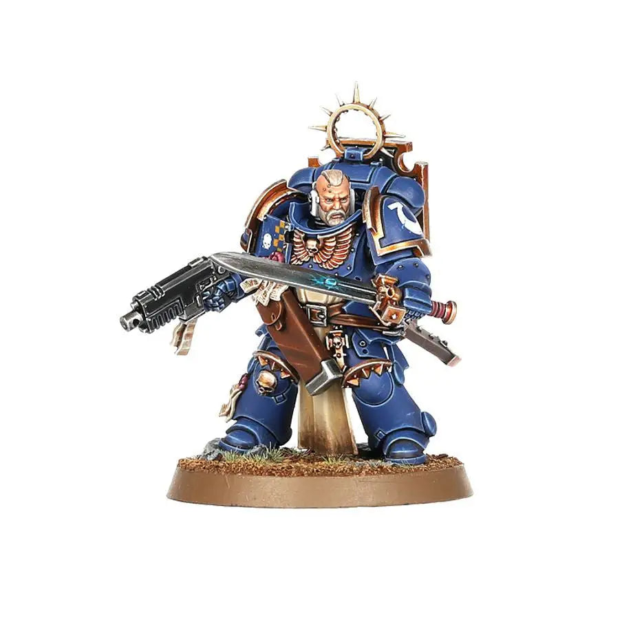 Highly detailed miniature of Space Marines Bladeguard Veterans in blue power armor with rifle and sword