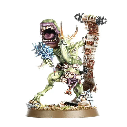 Painted miniature of a green monstrous creature with a gaping mouth holding a quill on scrolls for Warhammer Spearhead Maggotkin of Nurgle