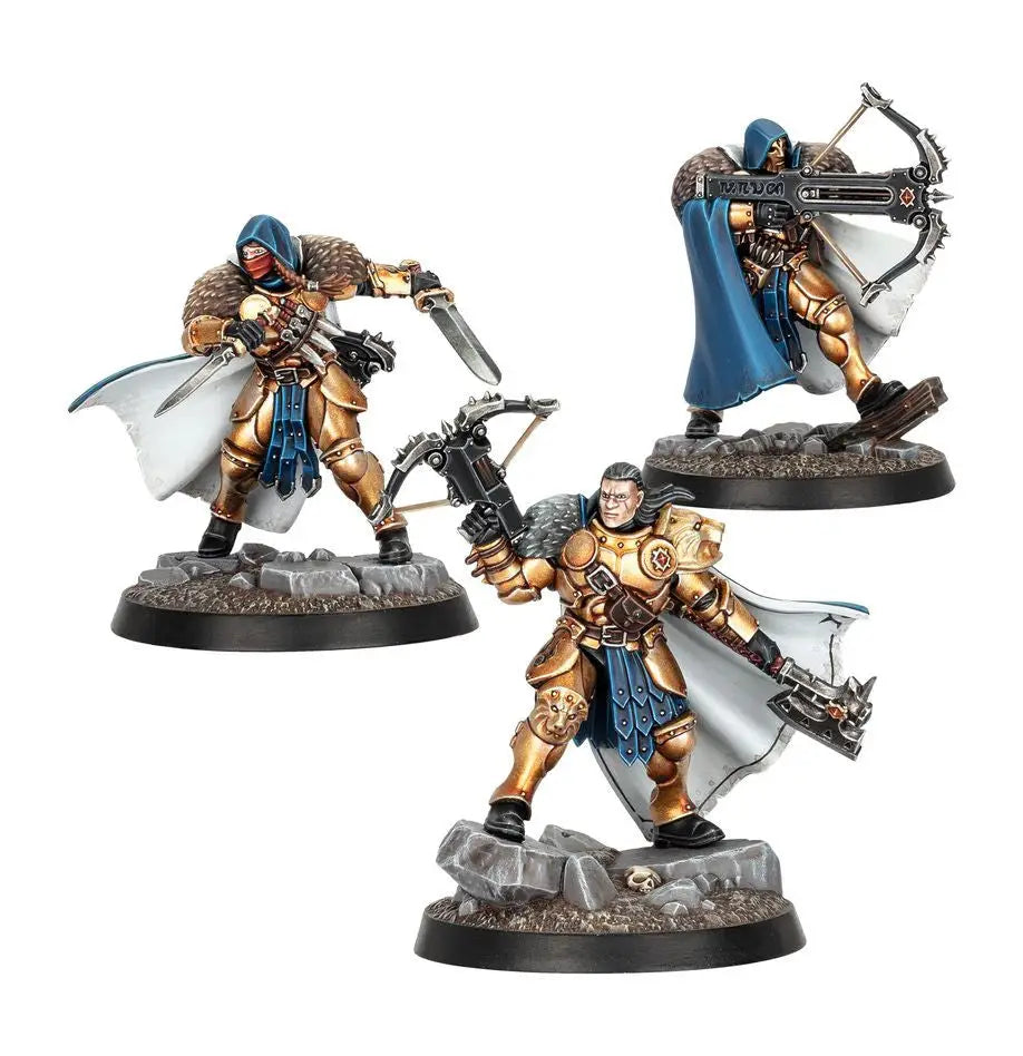 Three painted warriors in gold armor and blue cloaks from Warhammer Underworlds