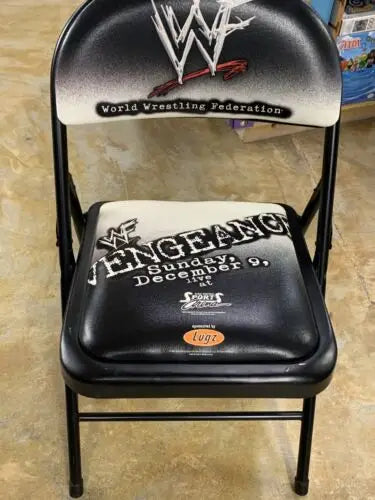 Black WWF World Wrestling Federation ringside chair with wrestling logos for collectors